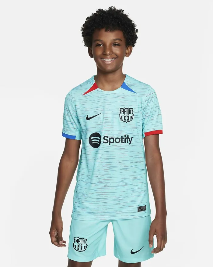 Kids FC Barcelona 202324 Stadium Third Light Aquaroyal Blueuniversity Redblack Nike Tops And TShirts Kids FC Barcelona 202324 Stadium Third Light Aquaroyal Blueuniversity Redblack Nike Tops And TShirts